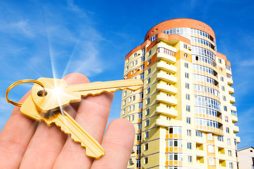 gold keys with house on blue sky